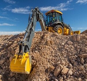 Use a backhoe to dig trenches