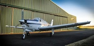 Plane in Front of Hangar